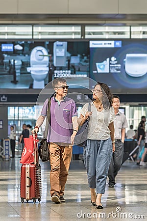 Fasionable couple at Beijing Raiway Station South, China Editorial Stock Photo